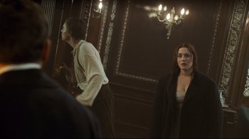 Movie still from “Titanic” (1997), directed by James Cameron – A man and a woman standing in front of a mirror; Medium shot, Over the shoulder angle