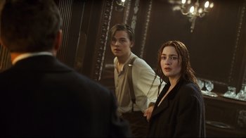 Movie still from “Titanic” (1997), directed by James Cameron – A man and a woman standing in front of a mirror; Medium shot, Over the shoulder angle