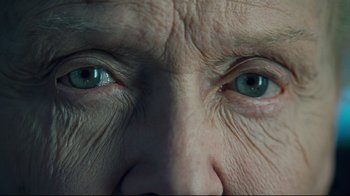 Movie still from “Titanic” (1997), directed by James Cameron – An older man's face with blue eyes and wrinkled skin; Extreme Close Up shot, Overhead angle