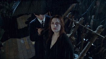 Movie still from “Titanic” (1997), directed by James Cameron – A man and a woman under an umbrella in the rain; Medium shot, High angle