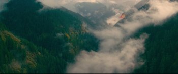 Movie still from “To All the Boys I've Loved Before” (2018), directed by Susan Johnson – A view of a mountain range with clouds in the air; Extreme Wide shot, High angle