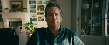 Movie still from “To All the Boys I've Loved Before” (2018), directed by Susan Johnson – A person sitting in a room; Close Up shot, Low angle