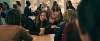 Movie still from “To All the Boys I've Loved Before” (2018), directed by Susan Johnson – A group of young people sitting at a table; Medium shot, Over the shoulder angle