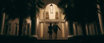Movie still from “To All the Boys I've Loved Before” (2018), directed by Susan Johnson – A man and a woman walking up the stairs of a house; Wide shot, Low angle