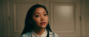 Movie still from “To All the Boys I've Loved Before” (2018), directed by Susan Johnson – A woman with long black hair wearing a white and blue shirt; Close Up shot, Over the shoulder angle
