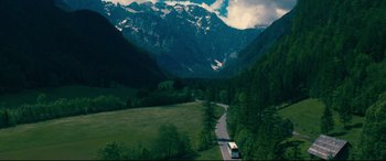 Movie still from “To All the Boys I've Loved Before” (2018), directed by Susan Johnson – A truck driving down a road in the middle of a valley; Extreme Wide shot, High angle