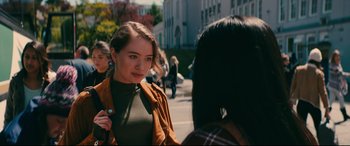 Movie still from “To All the Boys I've Loved Before” (2018), directed by Susan Johnson – A woman standing next to another woman on a sidewalk; Close Up shot, Over the shoulder angle