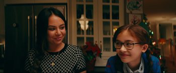 Movie still from “To All the Boys I've Loved Before” (2018), directed by Susan Johnson – A woman standing next to a young boy in front of a window; Close Up shot, Over the shoulder angle