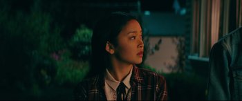 Movie still from “To All the Boys I've Loved Before” (2018), directed by Susan Johnson – A woman in a plaid jacket looking up at the sky; Close Up shot, Over the shoulder angle