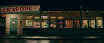 Movie still from “To All the Boys I've Loved Before” (2018), directed by Susan Johnson – A cafe is lit up at night in the dark; Extreme Wide shot, Low angle