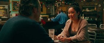 Movie still from “To All the Boys I've Loved Before” (2018), directed by Susan Johnson – Two people sitting at a table in a restaurant; Medium shot, Over the shoulder angle