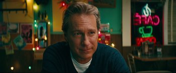 Movie still from “To All the Boys I've Loved Before” (2018), directed by Susan Johnson – A person sitting in a room; Close Up shot, Over the shoulder angle