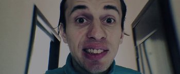 Movie still from “To the Lake” (2019), directed by Pavel Kostomarov – A person's face with an open mouth; Extreme Close Up shot, Low angle