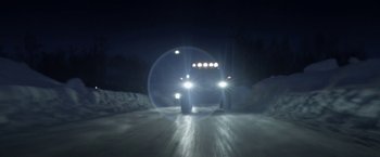 Movie still from “To the Lake” (2019), directed by Pavel Kostomarov – Two cars driving down a snowy road at night; Extreme Wide shot, Low angle