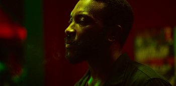 Movie still from “Top Boy” (2011), created by Ronan Bennett – A person wearing a black shirt; Close Up shot, Low angle