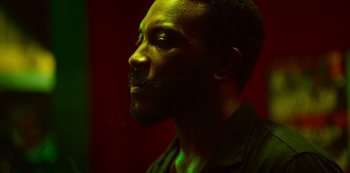 Movie still from “Top Boy” (2011), created by Ronan Bennett – A person wearing a black shirt; Close Up shot, Low angle