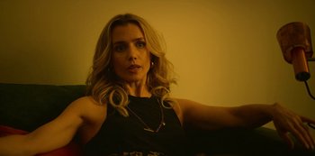 Movie still from “Top Boy” (2011), created by Ronan Bennett – A woman sitting on a couch in front of a window; Close Up shot, Low angle