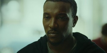 Movie still from “Top Boy” (2011), created by Ronan Bennett – A person wearing a black hoodie; Close Up shot, Low angle