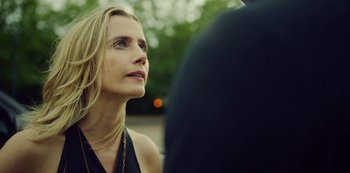 Movie still from “Top Boy” (2011), created by Ronan Bennett – A beautiful woman looking up at something in the distance; Close Up shot, Over the shoulder angle