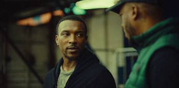 Movie still from “Top Boy” (2011), created by Ronan Bennett – A person wearing a jacket; Close Up shot, Over the shoulder angle
