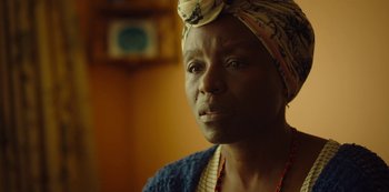 Movie still from “Top Boy” (2011), created by Ronan Bennett – An older woman with a head scarf on; Close Up shot, Over the shoulder angle