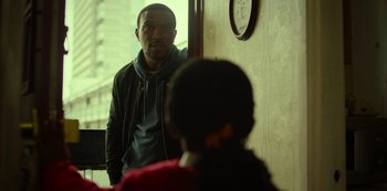 Movie still from “Top Boy” (2011), created by Ronan Bennett – A man standing in front of a mirror looking into the mirror; Medium shot, Over the shoulder angle