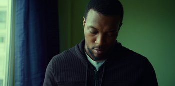 Movie still from “Top Boy” (2011), created by Ronan Bennett – A person with his eyes closed; Close Up shot, Low angle