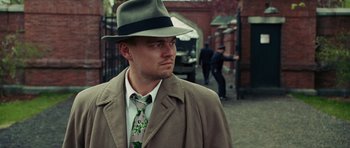Movie still from “Shutter Island” (2010), directed by Martin Scorsese – A man wearing a hat and a tie; Close Up shot, Low angle