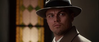 Movie still from “Shutter Island” (2010), directed by Martin Scorsese – A person wearing a hat; Close Up shot, Low angle