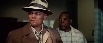 Movie still from “Shutter Island” (2010), directed by Martin Scorsese – A man in a suit and a man in a hat; Close Up shot, Low angle