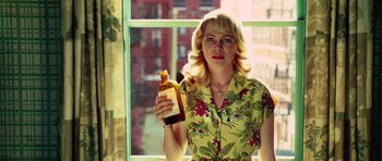 Movie still from “Shutter Island” (2010), directed by Martin Scorsese – A woman holding a bottle of alcohol in front of a window; Close Up shot, High angle