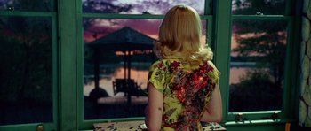 Movie still from “Shutter Island” (2010), directed by Martin Scorsese – A woman looking out of a window at the sunset; Medium shot, Over the shoulder angle