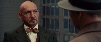 Movie still from “Shutter Island” (2010), directed by Martin Scorsese – A man in a suit and bow tie looking at another man in a hat; Close Up shot, Over the shoulder angle
