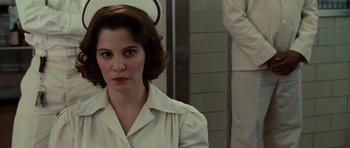 Movie still from “Shutter Island” (2010), directed by Martin Scorsese – A woman wearing a nurse's uniform in front of a mirror; Close Up shot, Over the shoulder angle