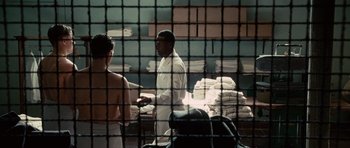 Movie still from “Shutter Island” (2010), directed by Martin Scorsese – A man and a woman standing in front of a jail cell; Medium shot, Over the shoulder angle