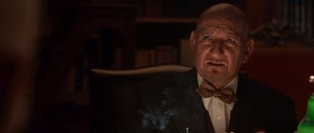 Movie still from “Shutter Island” (2010), directed by Martin Scorsese – An older man wearing a suit and bow tie; Close Up shot, Low angle