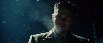 Movie still from “Shutter Island” (2010), directed by Martin Scorsese – A person wearing a suit and tie; Close Up shot, Low angle