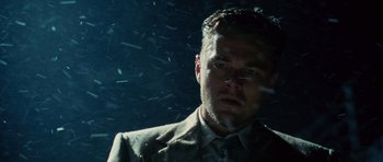 Movie still from “Shutter Island” (2010), directed by Martin Scorsese – A person wearing a suit and tie; Close Up shot, Low angle