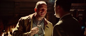 Movie still from “Shutter Island” (2010), directed by Martin Scorsese – A man smoking a cigarette while talking to another man; Close Up shot, Over the shoulder angle