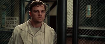 Movie still from “Shutter Island” (2010), directed by Martin Scorsese – A person in a prison uniform; Close Up shot, Low angle