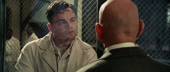 Movie still from “Shutter Island” (2010), directed by Martin Scorsese – A person looking at a person in a mirror; Close Up shot, Over the shoulder angle