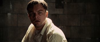 Movie still from “Shutter Island” (2010), directed by Martin Scorsese – A person wearing a white shirt; Close Up shot, Low angle