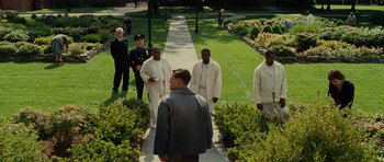 Movie still from “Shutter Island” (2010), directed by Martin Scorsese – A group of men standing on a path in a park; Wide shot, High angle