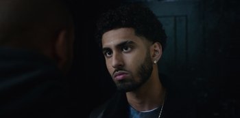 Movie still from “Top Boy” (2011), created by Ronan Bennett – A person wearing a jacket; Close Up shot, Over the shoulder angle