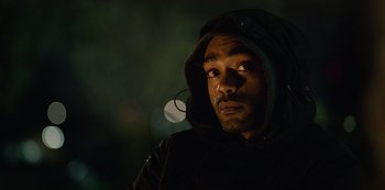Movie still from “Top Boy” (2011), created by Ronan Bennett – A person wearing a hooded jacket; Close Up shot, Low angle