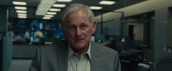 Movie still from “Sicario” (2015), directed by Denis Villeneuve – An older man in a gray suit and white shirt; Close Up shot, Over the shoulder angle