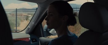 Movie still from “Sicario” (2015), directed by Denis Villeneuve – A woman sitting in the driver's seat of a car; Close Up shot, Over the shoulder angle
