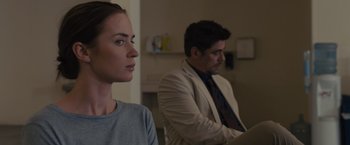 Movie still from “Sicario” (2015), directed by Denis Villeneuve – A man and a woman sitting next to each other in a room; Close Up shot, Over the shoulder angle