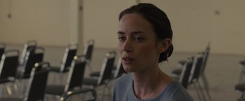 Movie still from “Sicario” (2015), directed by Denis Villeneuve – A person sitting in front of some chairs; Close Up shot, Over the shoulder angle