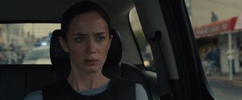 Movie still from “Sicario” (2015), directed by Denis Villeneuve – A woman sitting in the back seat of a car; Close Up shot, Over the shoulder angle